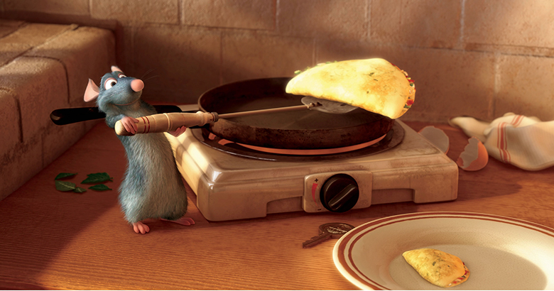 Ratatouille. Descrição da imagem: rato tirando uma omelete da frigideira com uma espátula.